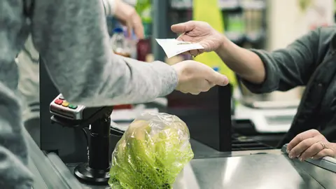 Getty Images People using cash at checkouts