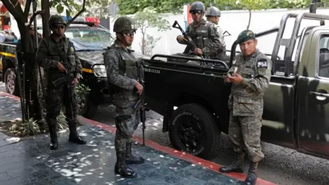 Reuters Members of the Guatemalan Military Police stand guard outside a hotel in Guatemala City, Guatemala, July 31, 201