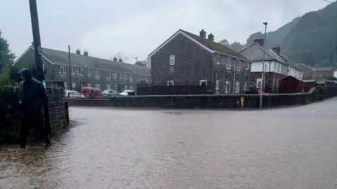 PA Media Residential roads were flooded in Port Talbot, Wales