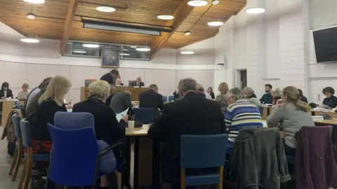 Carmelo Garcia The meeting taking place at Tewkesbury Borough Council