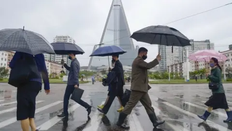 Reuters People wear masks on the streets of Pyongyang, North Korea. File photo