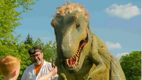 Maidstone Borough Council Father showing his son a dinosaur sculpture