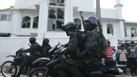 Getty Images Police ride past the Jumha Mosque