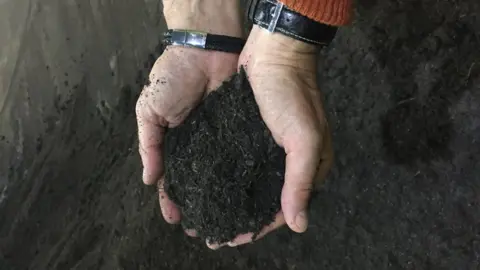 Jenny Grant Hands holding compost