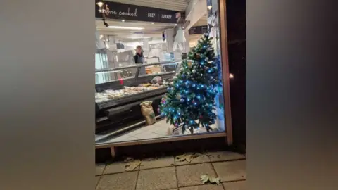 Joe Simpson March Quality Meats butchers' window display