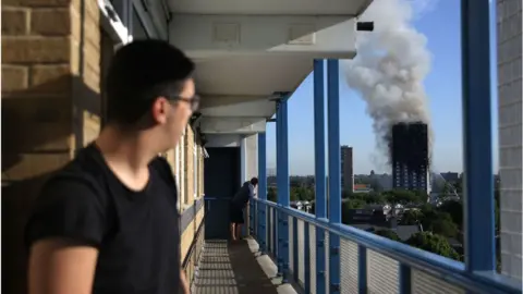 Getty Images man looks at fire