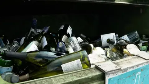 BBC A recycling bank full of glass bottles