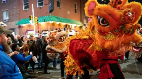 Getty Images People celebrate the Lunar New Year of the Dragon in the streets of Philadelphia, Pennsylvania of United States on February 10, 2024.