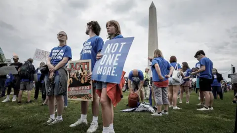 Reuters Protesters hold placards at the rally in Washington DC