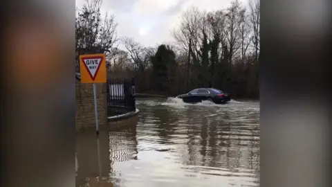 Watling Reclamation Water sprays up from a car on the A5 near Towcester