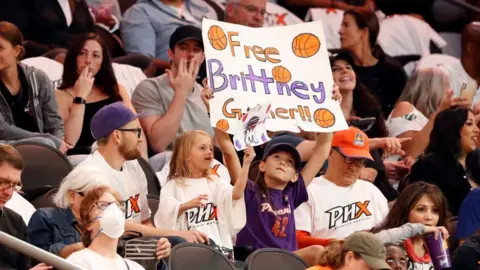 Getty Images A young fan holds a sign honouring Brittney Griner during the game between the Phoenix Mercury and the Las Vegas Aces at Footprint Center on 6 May, 2022 in Phoenix, Arizona