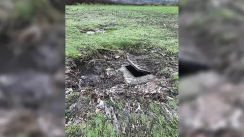 Penallta RFC A manhole cover which has been blown open by sewer water