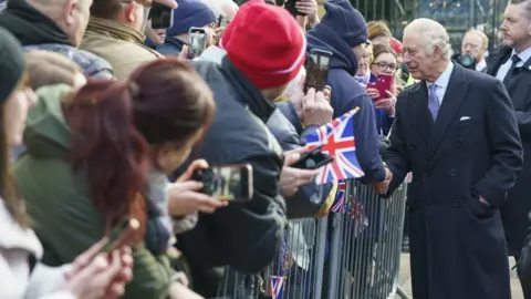 PA Media King Charles III meets members of the public as he arrives to attend a celebration at St Giles' Church to mark Wrexham becoming a City. Picture date: Friday December 9, 2022. PA Photo. See PA story ROYAL King. Photo credit should read: Dominic Lipinski/PA Wire