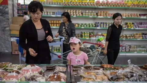 Getty Images In a photo taken on June 4, 2017 shoppers browse products on display at the Kwangbok, or 'liberation', department store in Pyongyang.