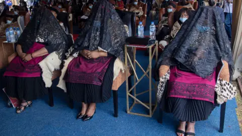 EPA The shrouded queens - the three widows of King Goodwill Zwelithini - at his memorial service in Nongoma, South Africa - 18 March 2021