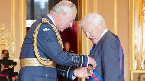 PA Media Sir David being honoured by the Prince of Wales