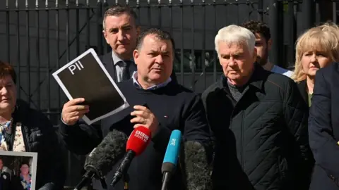 Pacemaker Family with redacted documents outside court