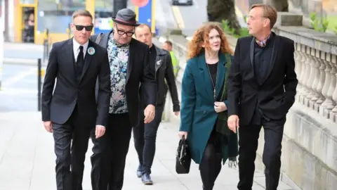 PA Antony Cotton (left) and Jennie McAlpine (second right) arrive at the funeral service of Martyn Hett,