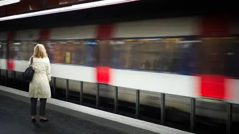 Getty Images File picture of a woman waits for a train on a platform at Auber train station in Paris