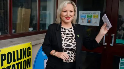 PA Media Michelle O'Neill arrives to cast her vote at the Clonoe polling station on Thursday