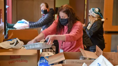Getty Images A Social Worker with the Reading School District, Pennsylvania, helps to pack up meals to be distributed on December 22, 2020