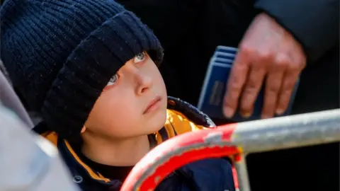 EPA A child who fled Ukraine after the Russian war waits outside an immigration centre office in Brussels, Belgium, 18 March 2022.