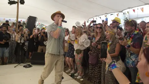 Getty Images Ronan Keating singing karaoke at the Kiwi Camp during Isle Of Wight Festival 2021