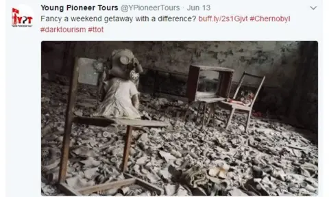 Twitter/@YPioneerTours Doll wearing a gas mask in Chernobyl ruins