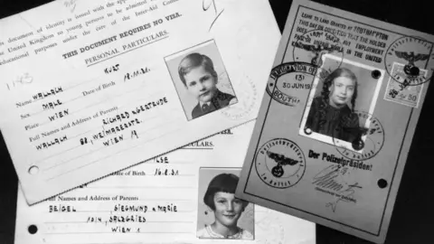 Getty Images Travel documents for three children who travelled on the Kindertransport.