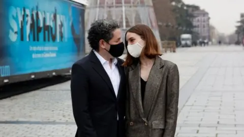 EPA Venezuelan maestro Gustavo Dudamel (L) and Spanish actress Maria Valverde (R) pose for the photographers during the launching of project "Symphony" outside the Royal Opera House in Madrid, Spain, 21 December 2020