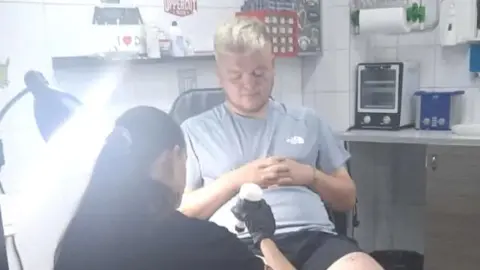 Callum Taylor Man getting tattoo