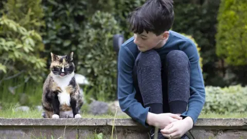 PA Media Elliot Abery, with his pet cat Chicken