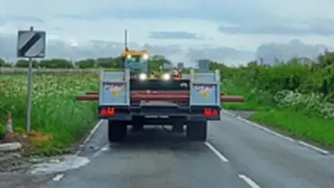 the tractor driving down the road