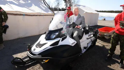 Getty Images Prince Charles sits astride a snow mobile