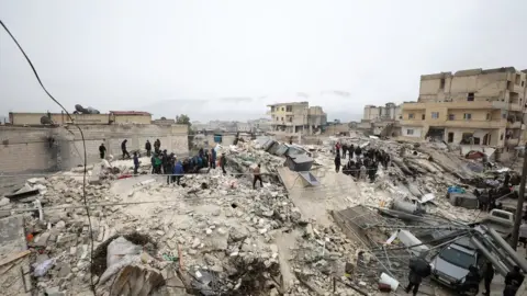 YAHYA NEMAH/EPA-EFE/REX/Shutterstock  Rescuers work at the site of a collapsed building following an earthquake in Armanaz town, Idlib Governorate, Syria 06 February 2023.