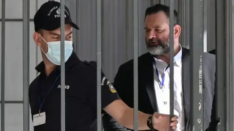 Getty Images European Parliament member Ioannis Lagos waits for his sentencing in court on October 12, 2020 in Athens, Greece.