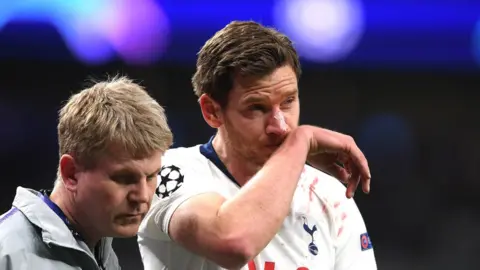 Getty Images Vertonghen helped off the pitch by a physio