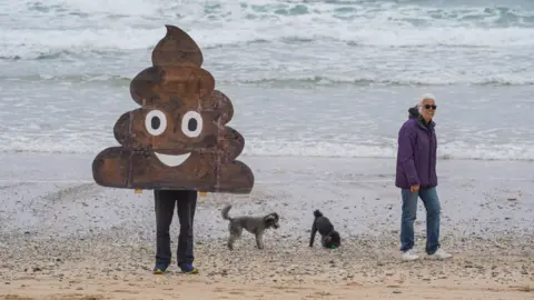 Getty Images Protests are called attention to the problem of sewage on England's beaches