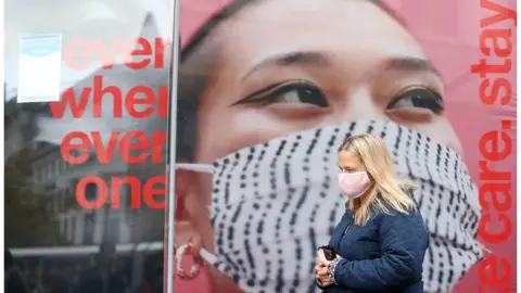 PA Media Woman wearing a mask