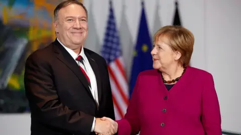 Reuters German Chancellor Angela Merkel shakes hands with US Secretary of State Mike Pompeo during a news conference in Berlin, Germany November 8, 2019
