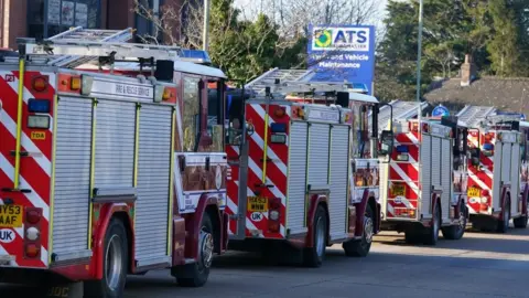 PA Media The fire trucks leaving