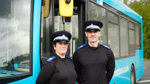 West Yorkshire Combined Authority PCSOs Jessica and Matt next to a bus