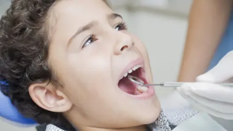 Getty Images Child at dentist having examination