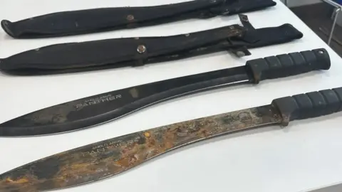 Northumbria Police Two machetes with their sleeves.