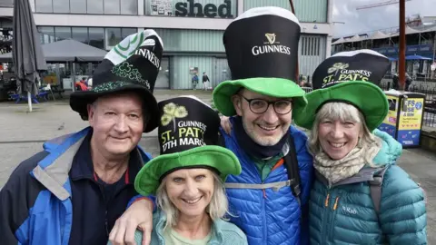 Plaster Communications People wearing Irish hats at the start of the St Patrick's Day parade in Bristol