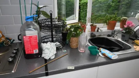 Durham Police/CPS A bamboo cane on a kitchen worktop surrounded by glasses and drinks bottles