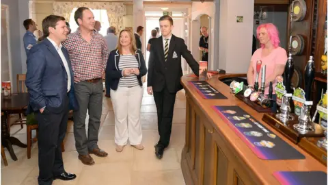 Getty Images MP Robert Jenrick in a pub with others