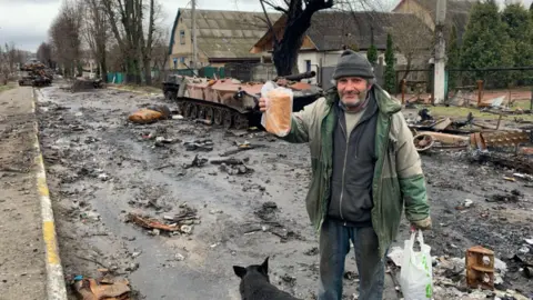 BBC/Kathy Long A local resident in Bucha with a loaf of Bread