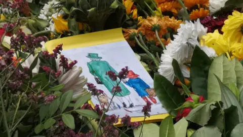 BBC Eleanor's artwork left among floral tributes