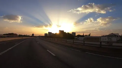 GRBiker The sun over London, seen from a rooftop-level flyover